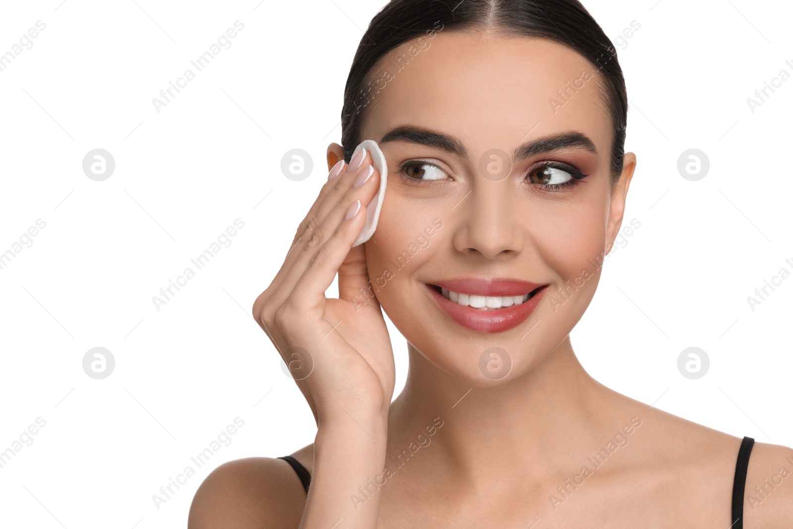 Photo of Beautiful woman removing makeup with cotton pad on white background