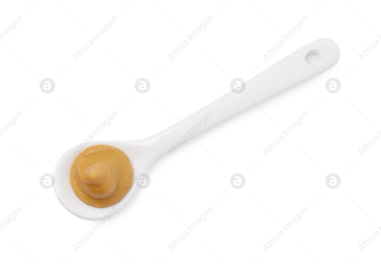 Photo of Fresh tasty mustard sauce in spoon isolated on white, top view