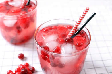 Photo of Glasses of natural lemonade with berries on table, closeup