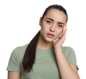 Young woman suffering from headache on white background