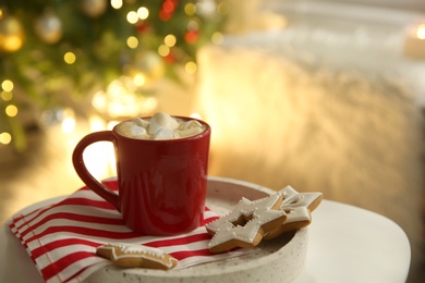 Cup of hot  drink on white table indoors