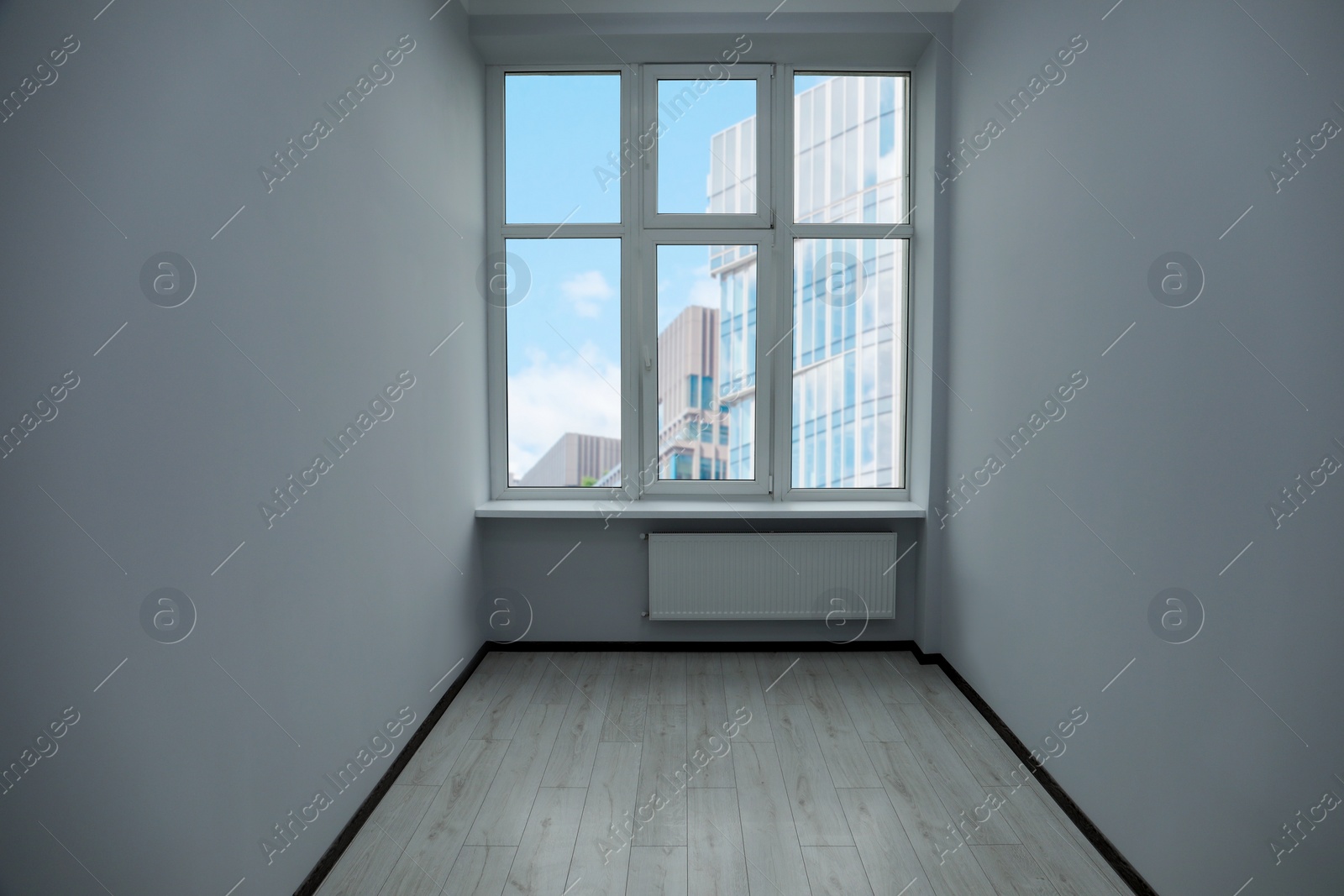 Photo of New empty room with clean windows and white walls