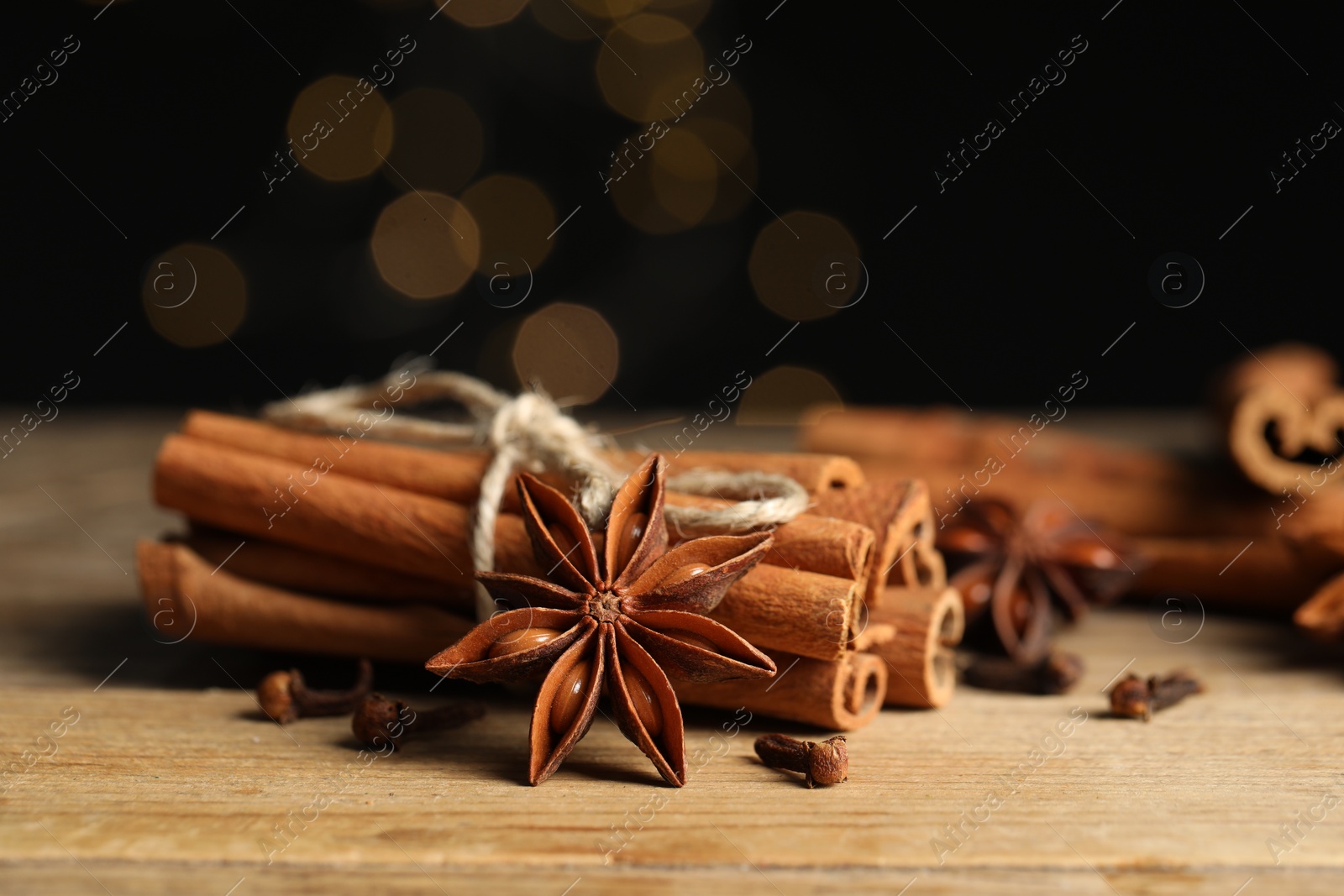 Photo of Different aromatic spices on wooden table, closeup