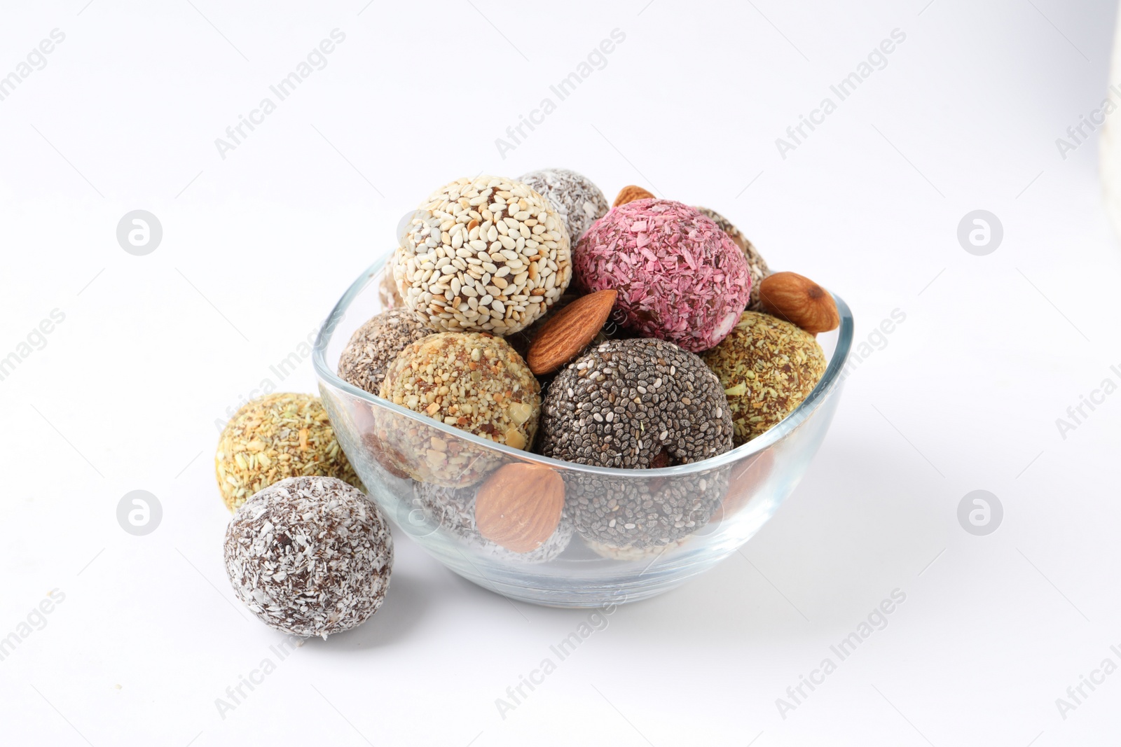 Photo of Different delicious vegan candy balls with almonds on white background