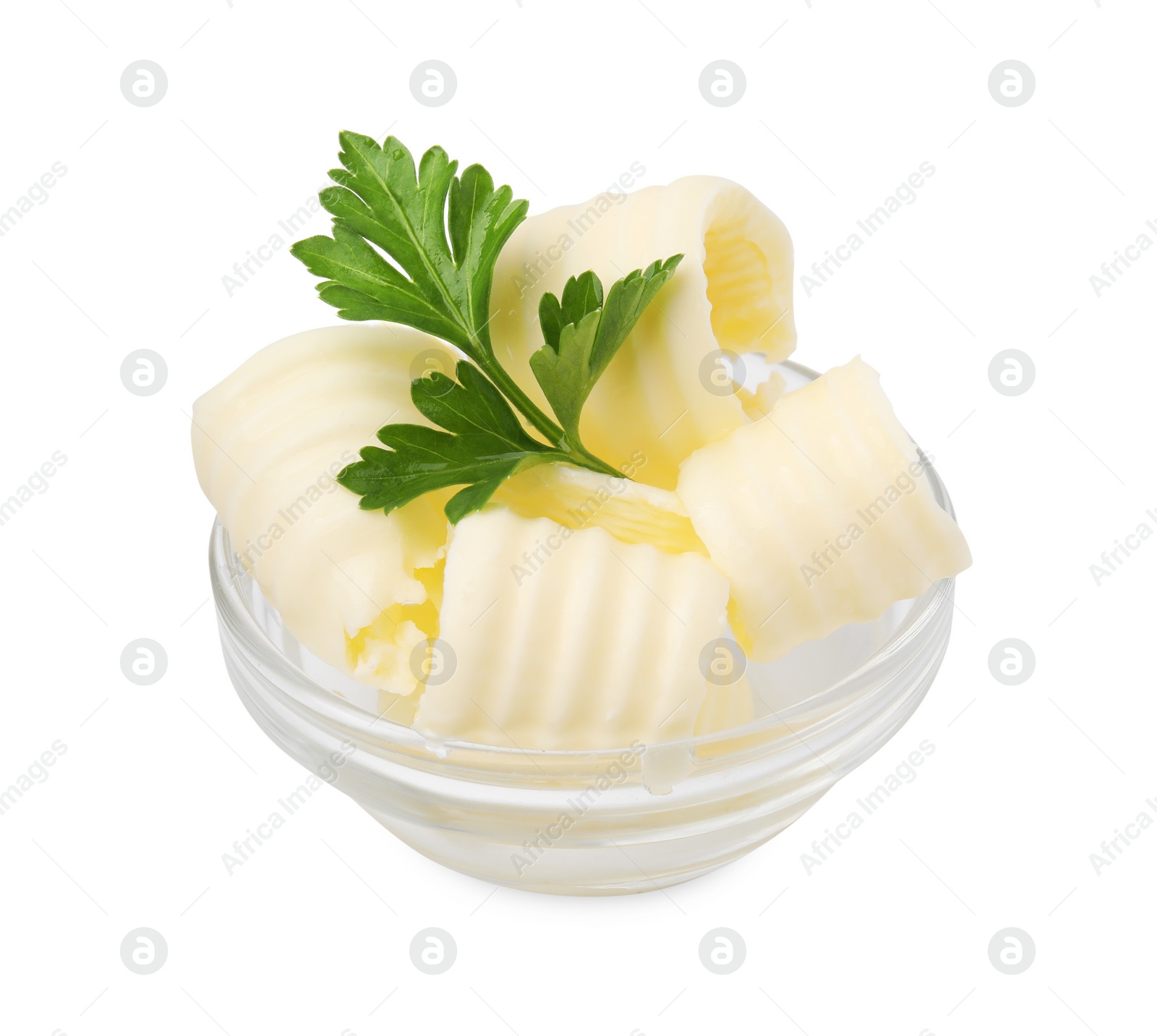 Photo of Tasty butter curls and fresh parsley in bowl isolated on white