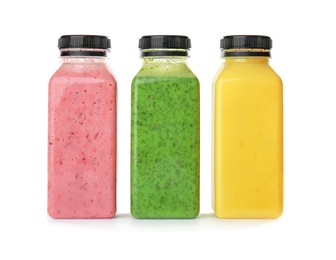 Photo of Bottles with delicious detox smoothies on white background