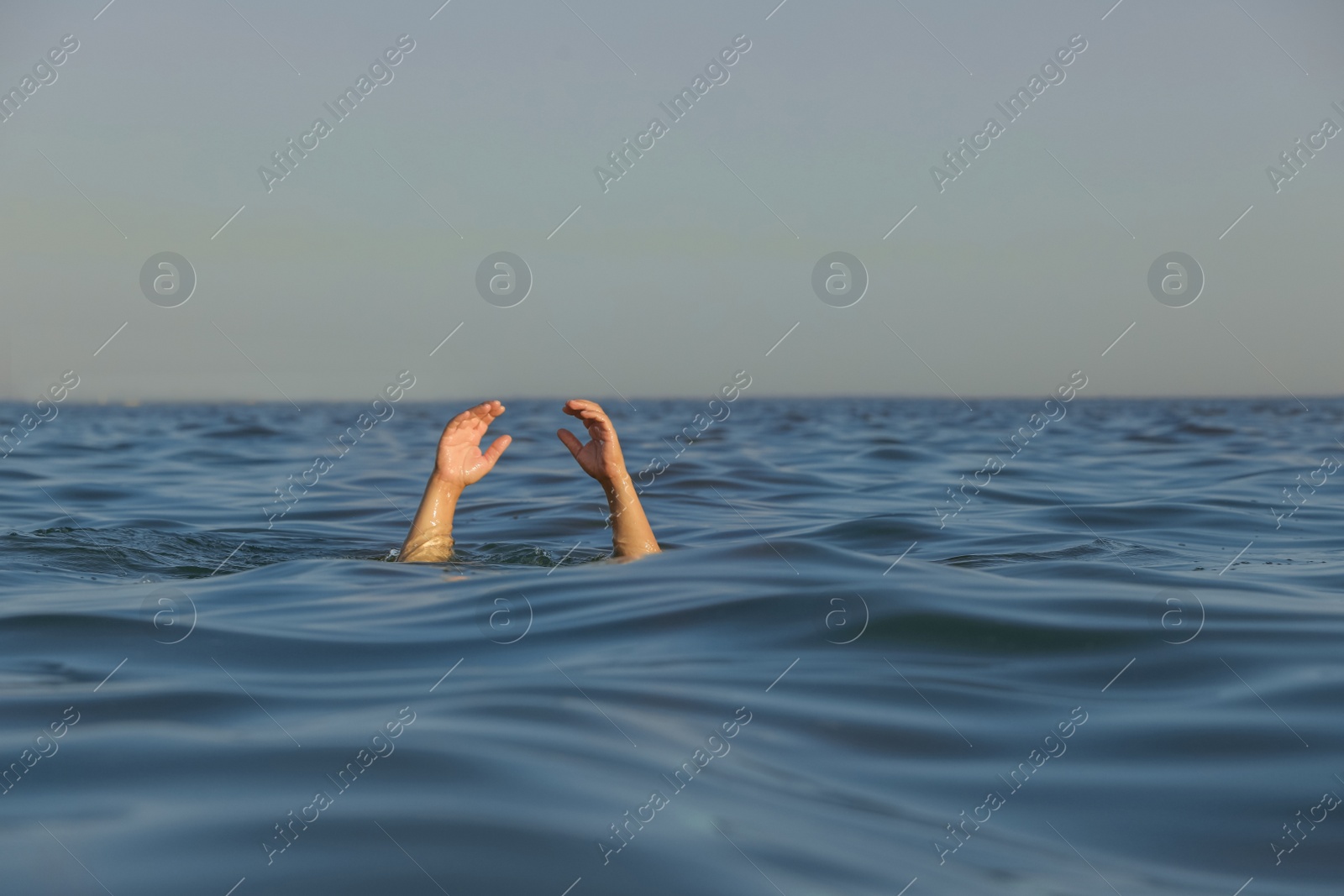 Photo of Drowning man reaching for help in sea