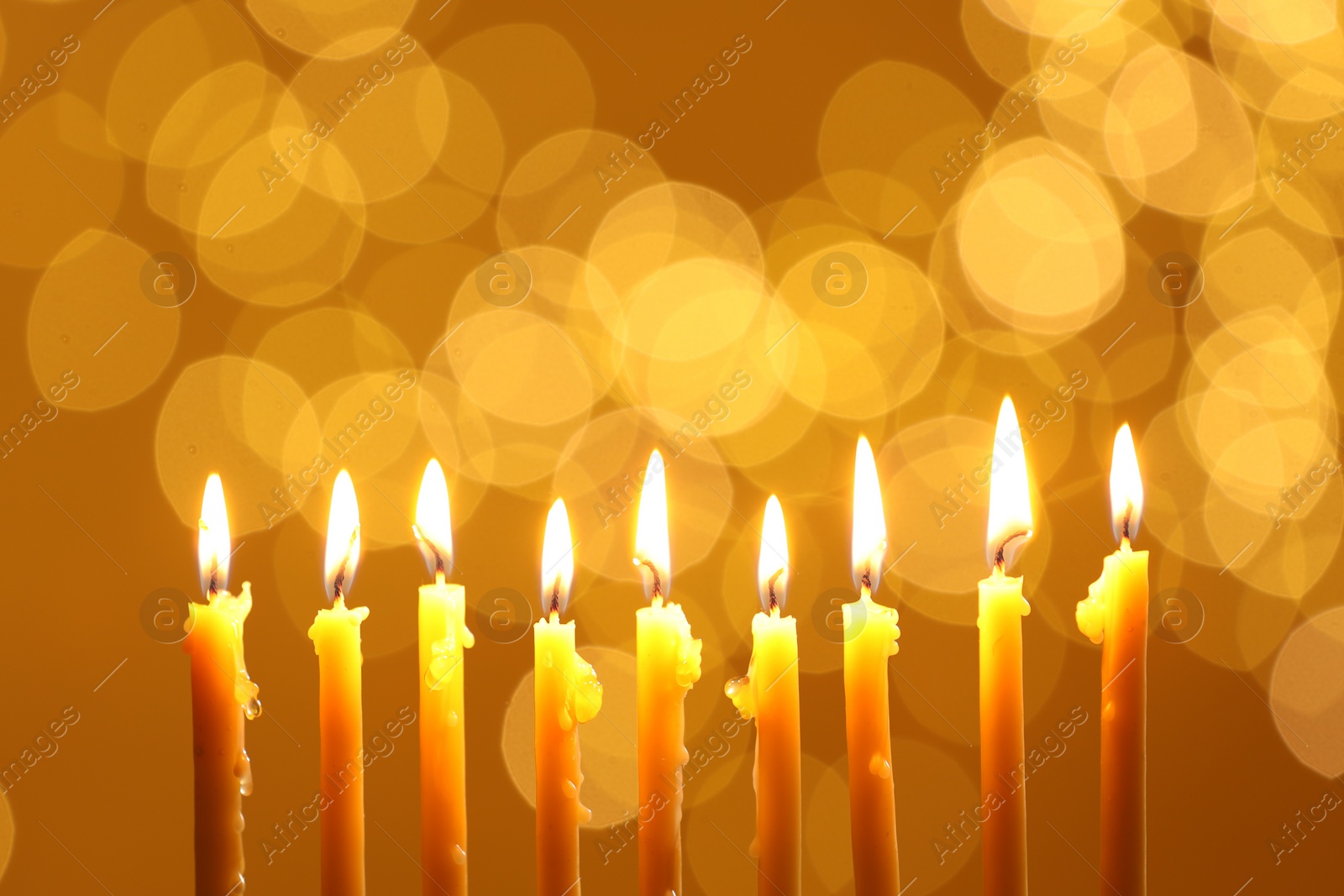 Photo of Hanukkah celebration. Burning candles against blurred lights