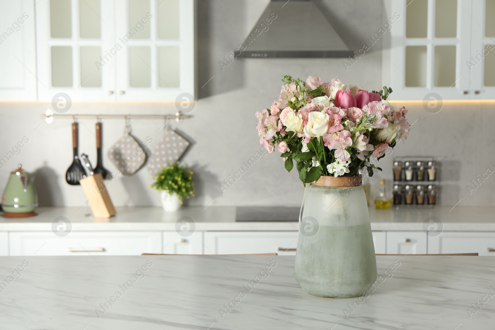 Photo of Beautiful bouquet of fresh flowers in vase on table indoors, space for text