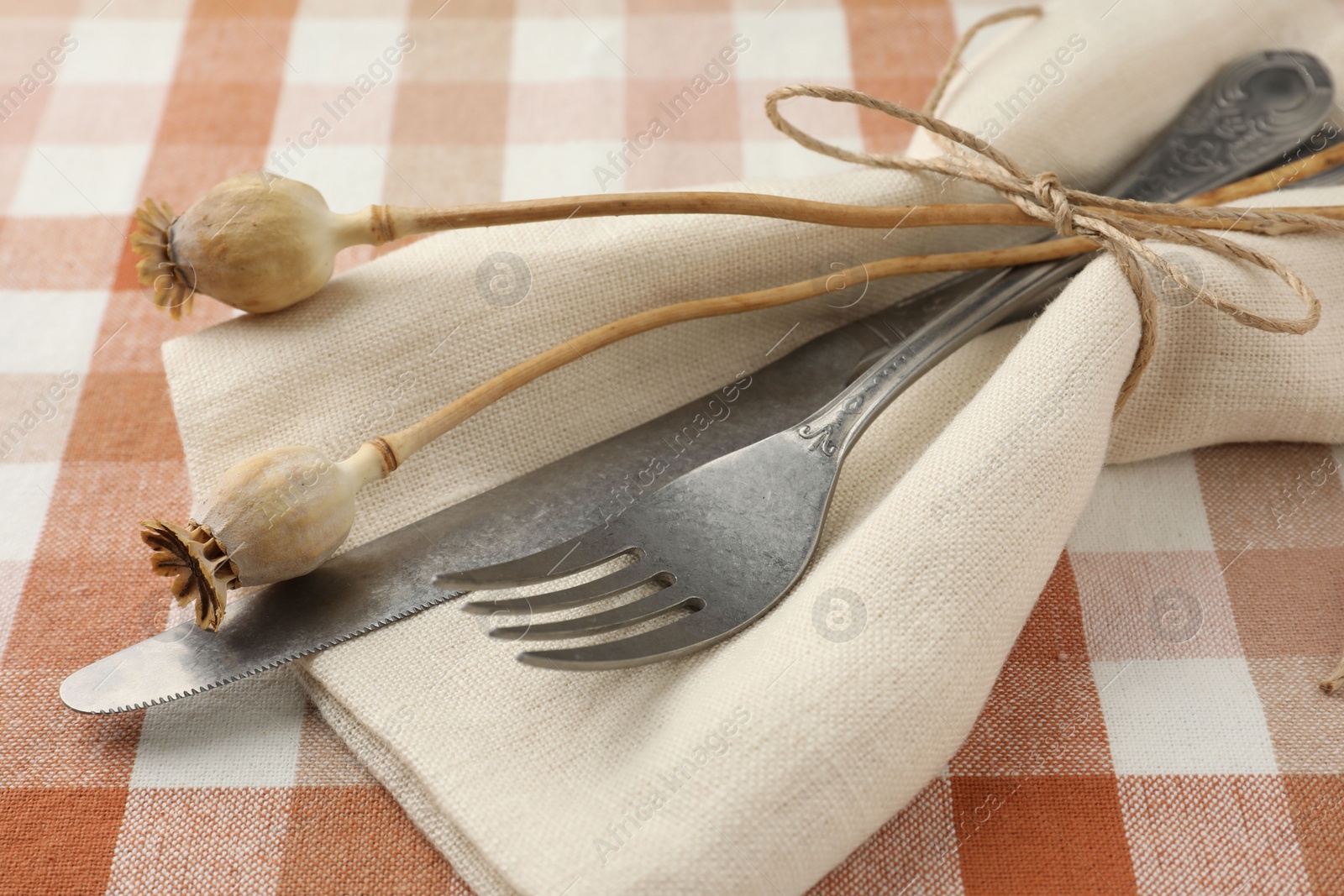 Photo of Stylish setting with cutlery and napkin on table, closeup