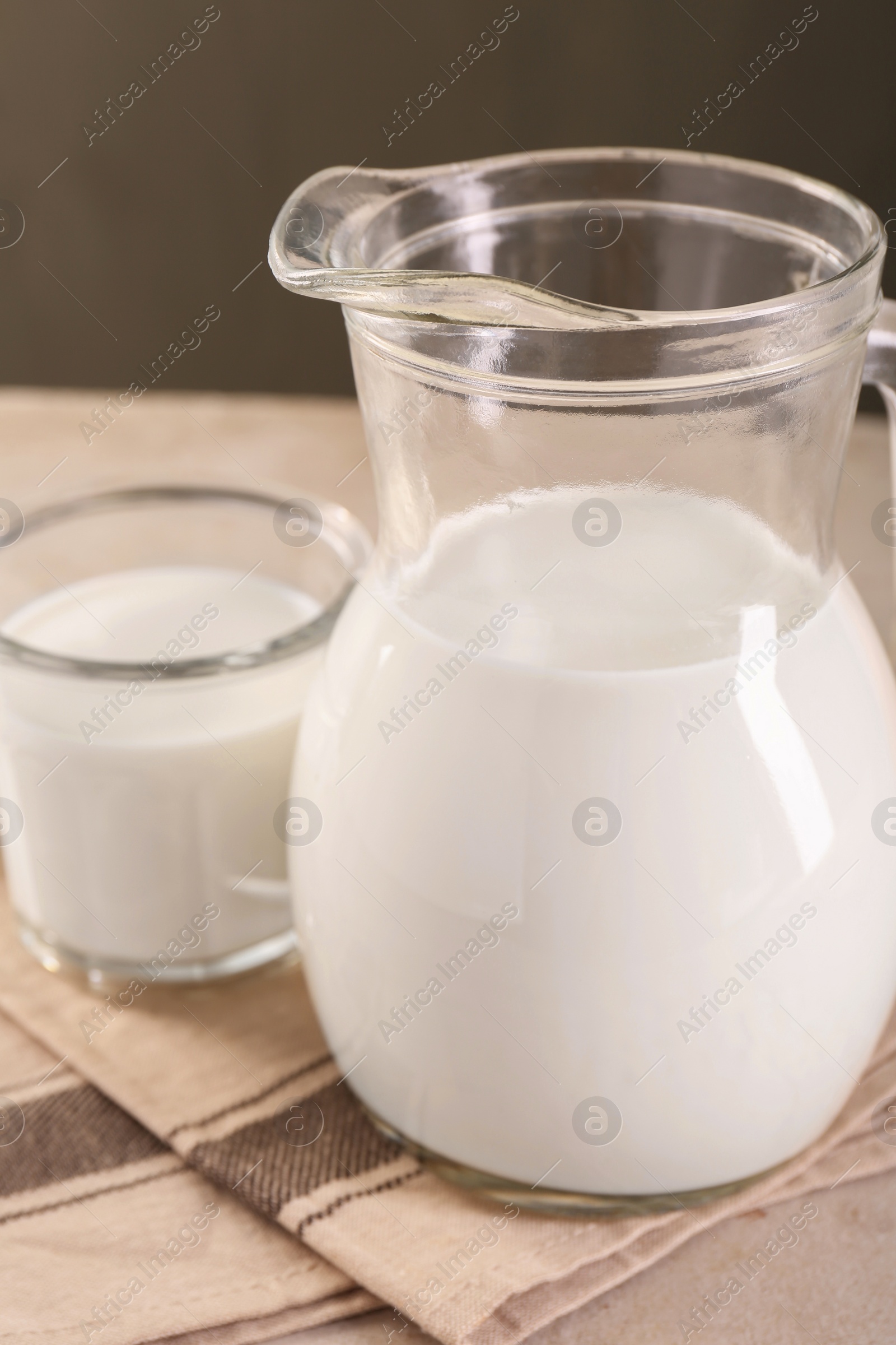 Photo of Glassware with tasty milk on table, closeup