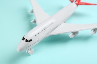 Photo of Toy airplane on light blue background, closeup