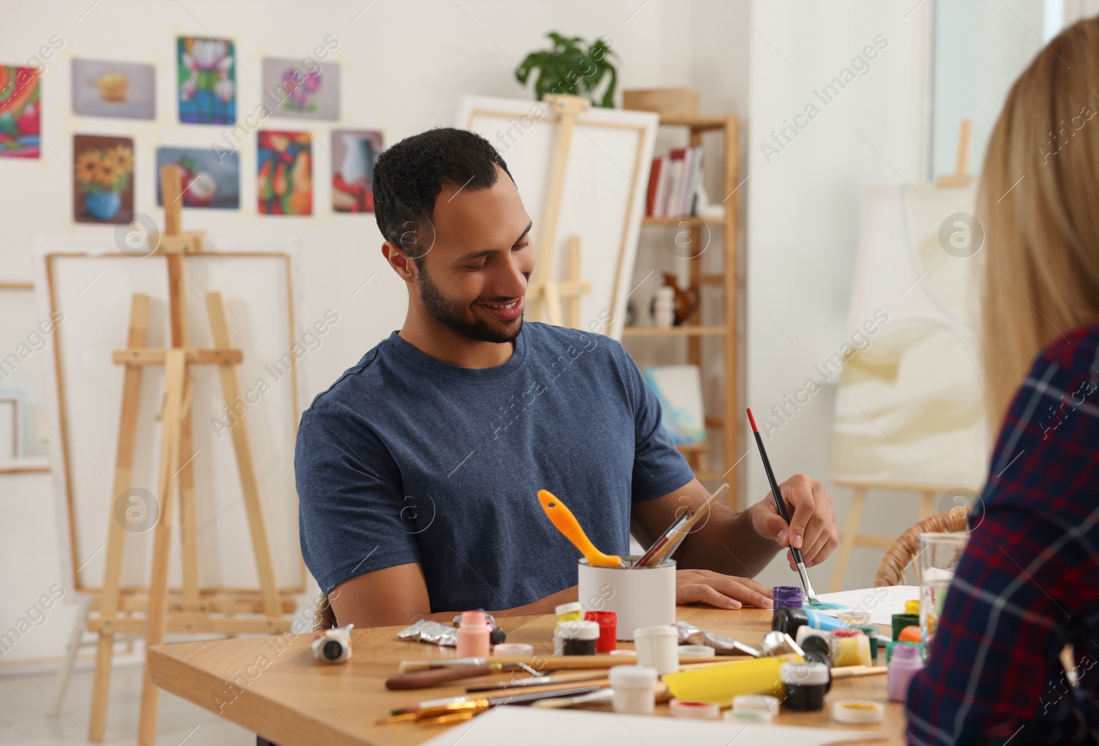 Photo of Students attending painting class in studio. Creative hobby