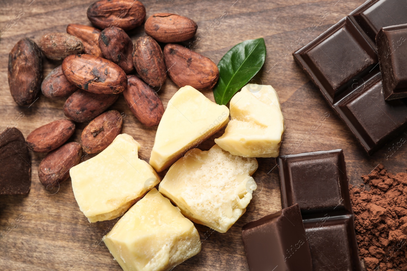 Photo of Flat lay composition with organic cocoa butter on wooden table