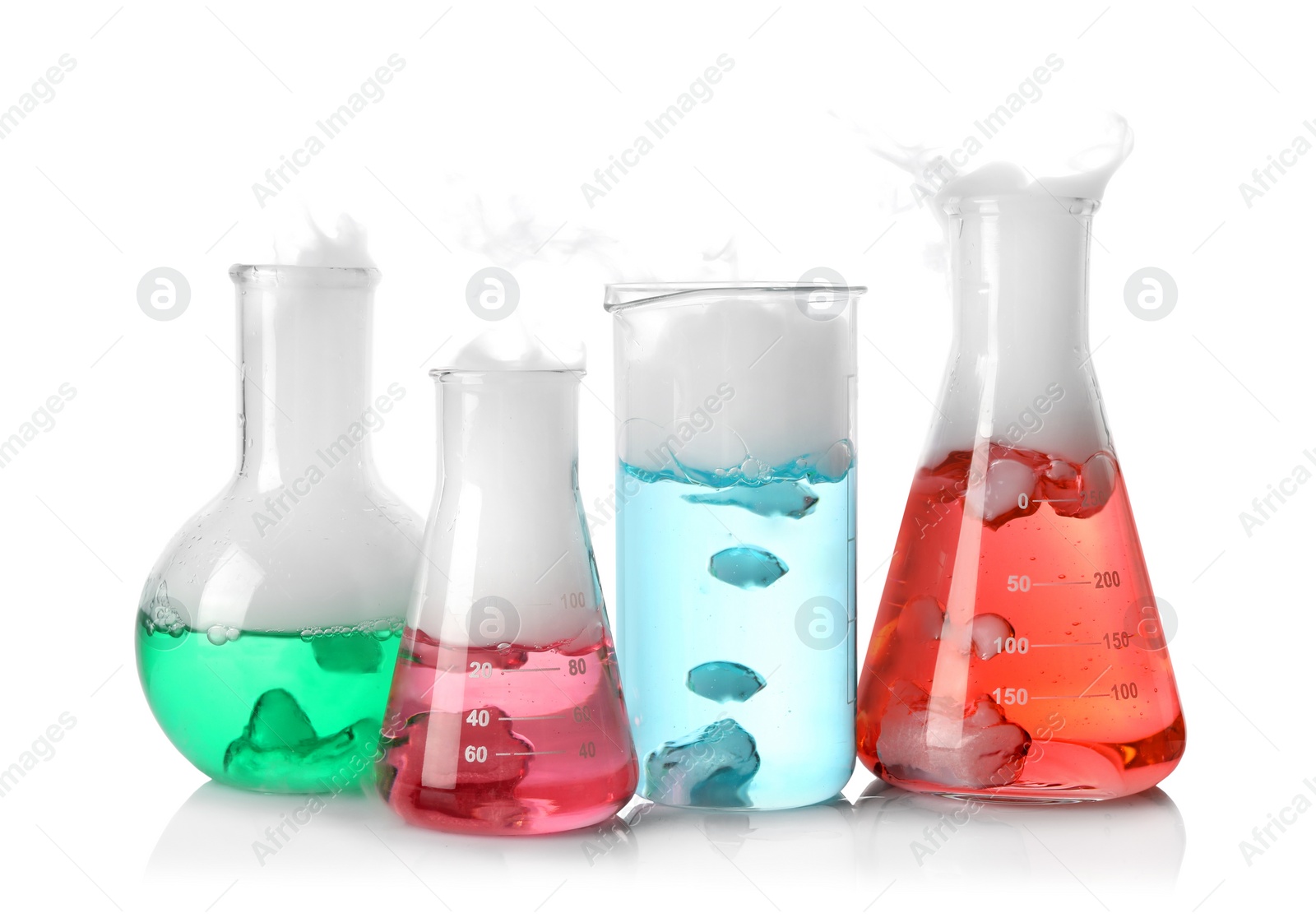 Photo of Laboratory glassware with colorful liquids and steam isolated on white. Chemical reaction