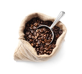 Photo of Bag with scoop and roasted coffee beans on white background, top view