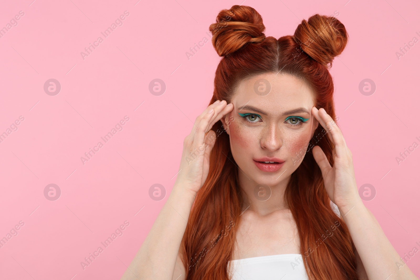 Photo of Portrait of beautiful woman with bright makeup on pink background. Space for text