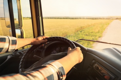 Man driving modern truck on sunny day, closeup