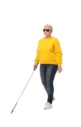 Mature blind person with long cane walking on white background