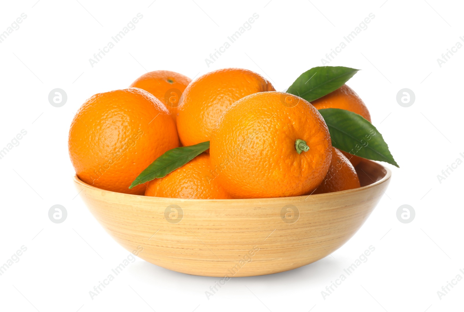 Photo of Fresh ripe oranges with green leaves in wooden bowl isolated on white