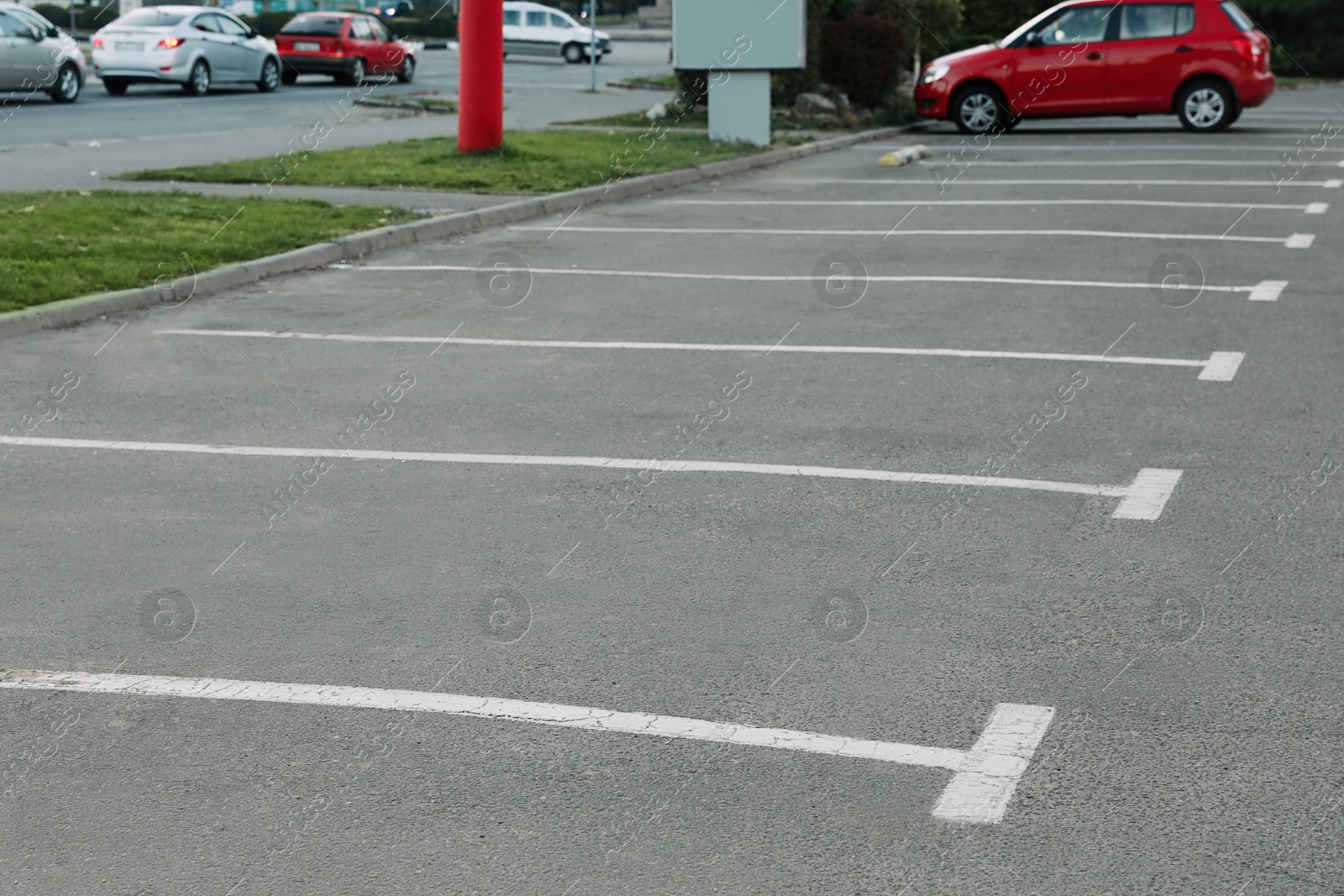 Photo of Car parking lots with white marking lines outdoors