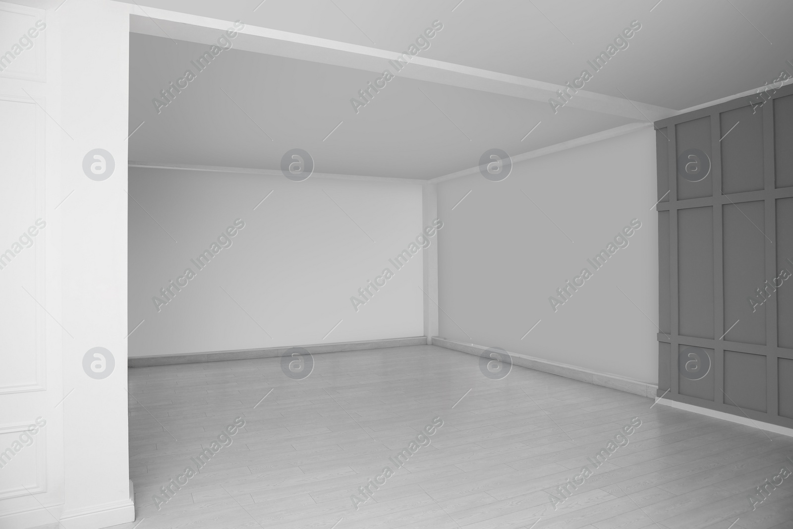 Photo of Empty room with grey wall and laminated floor