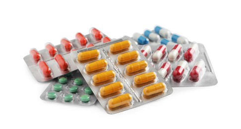 Photo of Pile of different pills in blister packs on white background