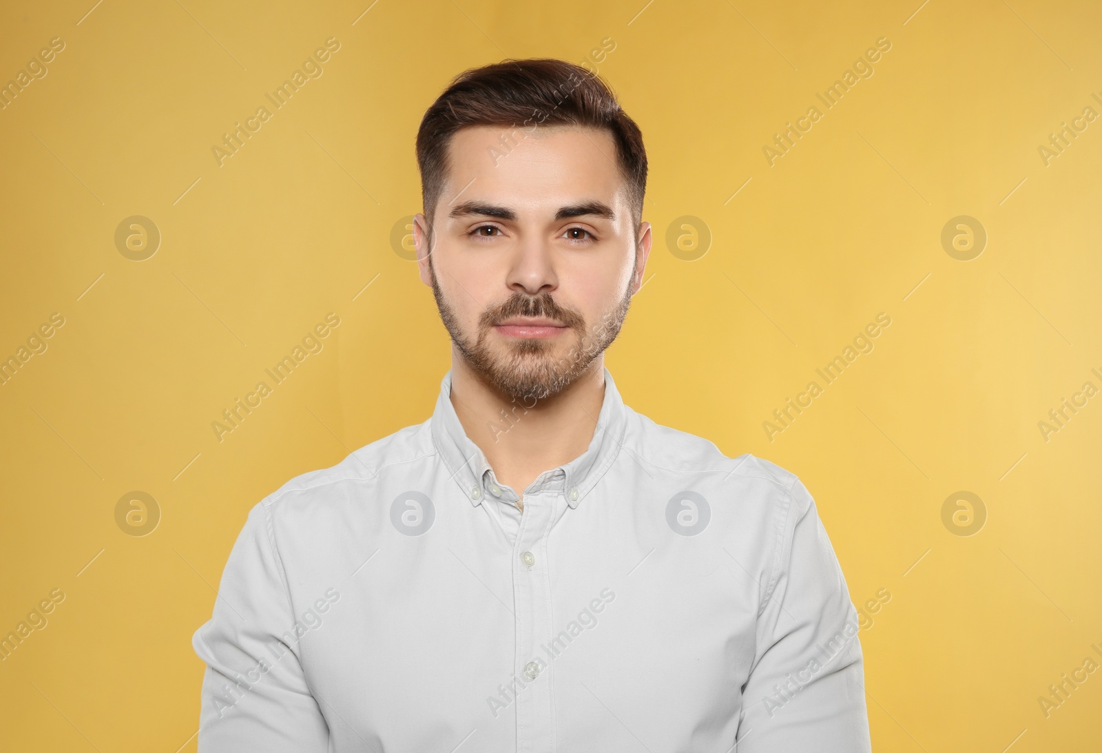 Photo of Portrait of handsome young man on color background