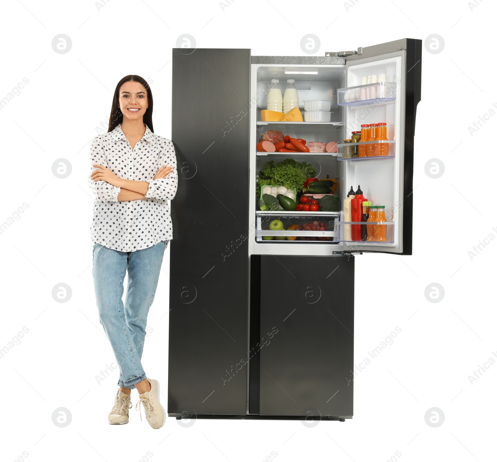 Photo of Young woman near open refrigerator on white background