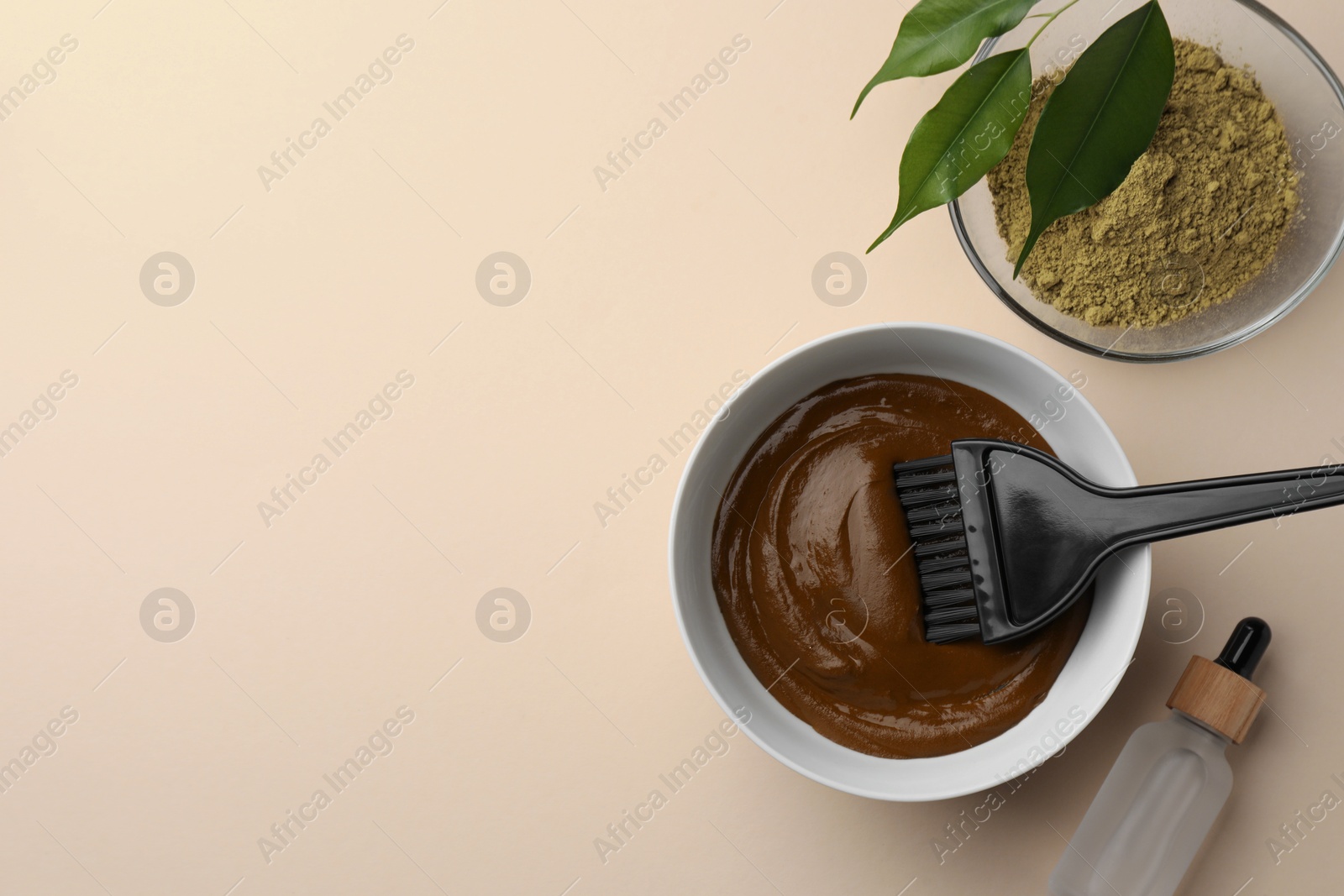 Photo of Henna powder and cream, bottle of liquid on beige background, flat lay with space for text. Natural hair coloring