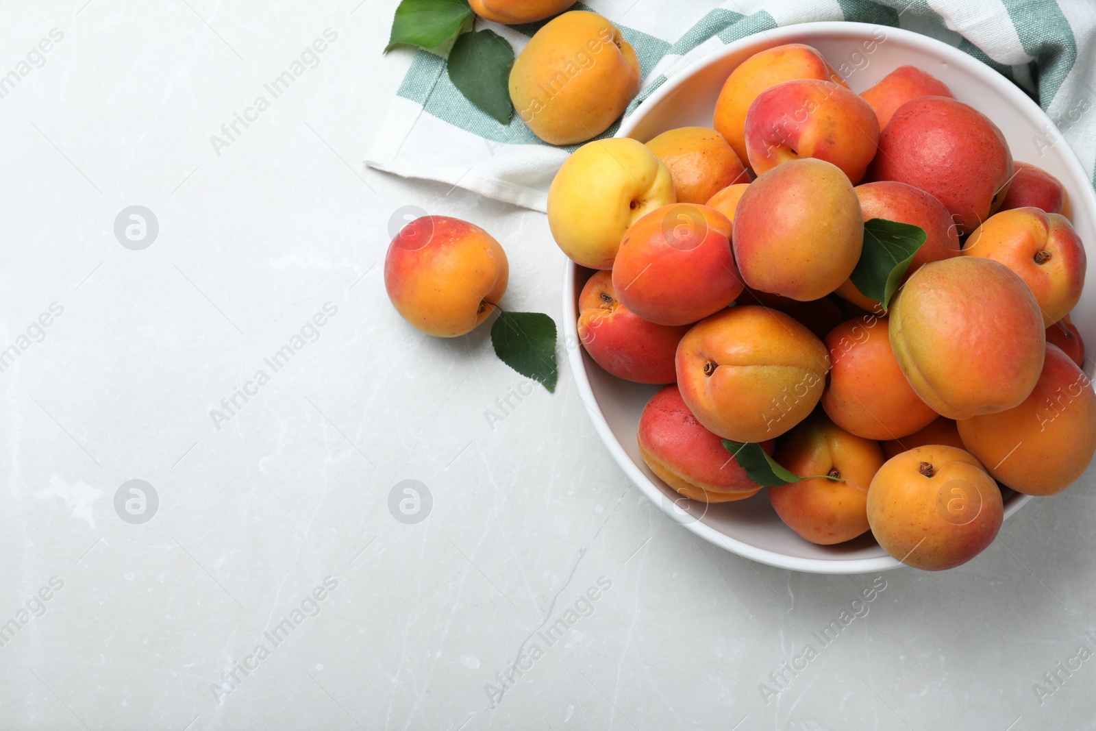 Photo of Delicious fresh ripe apricots on white table, flat lay. Space for text