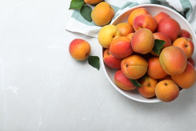 Photo of Delicious fresh ripe apricots on white table, flat lay. Space for text