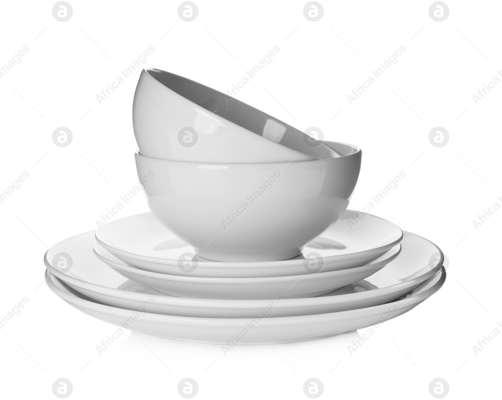 Photo of Stack of clean dishware isolated on white