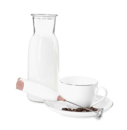 Mini mixer (milk frother), cup, coffee beans and bottle isolated on white