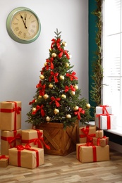 Decorated Christmas tree with gifts. Festive interior