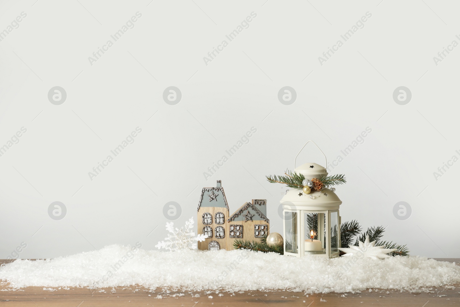 Photo of Beautiful composition with vintage Christmas lantern and festive decorations on snow against white background. Space for text