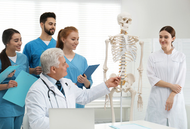 Photo of Professional orthopedist teaching medical students in clinic