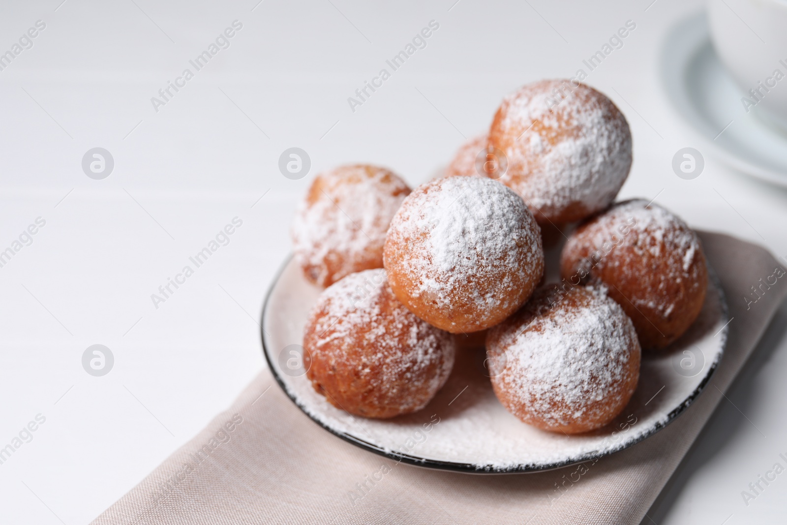 Photo of Delicious sweet buns on white table, closeup. Space for text