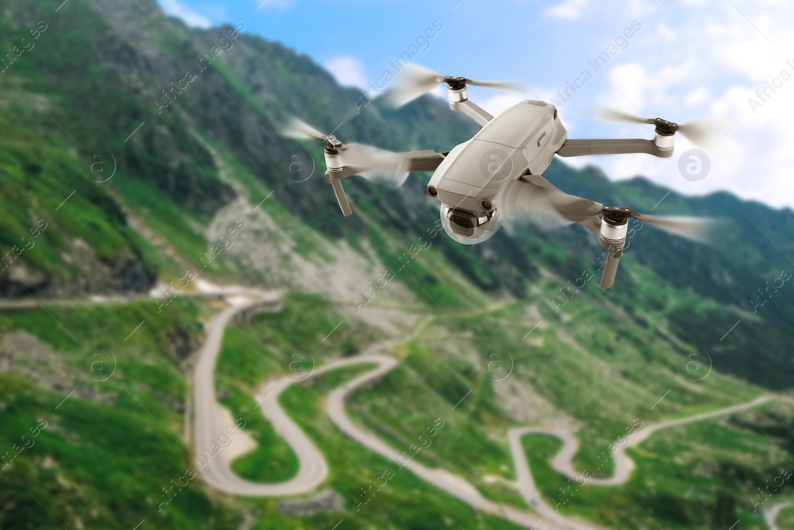 Image of Modern drone flying over picturesque mountains. Aerial survey