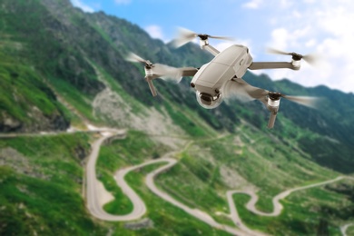 Image of Modern drone flying over picturesque mountains. Aerial survey