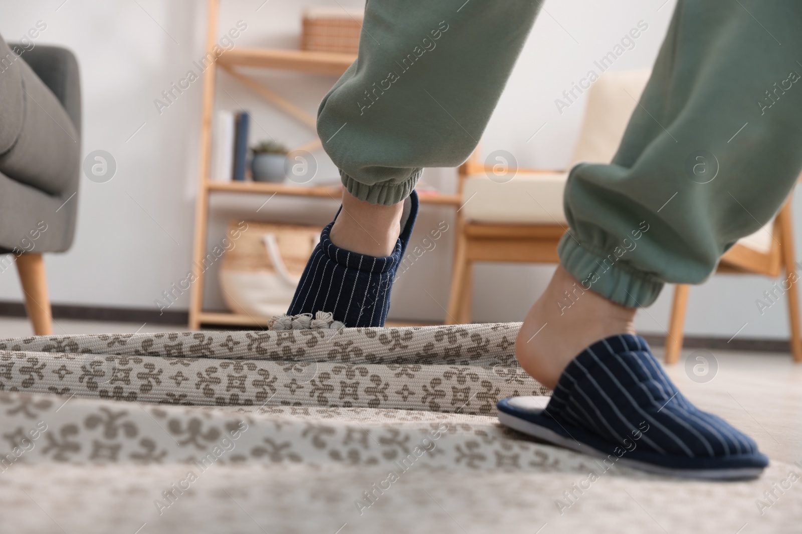 Photo of Man tripping over rug at home, closeup