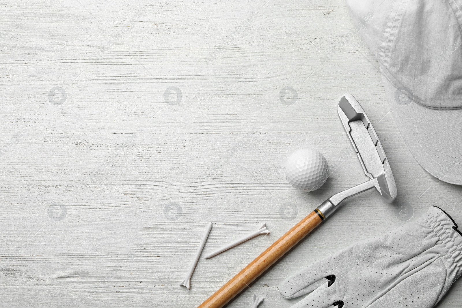 Photo of Flat lay composition with golf accessories and space for text on white wooden background