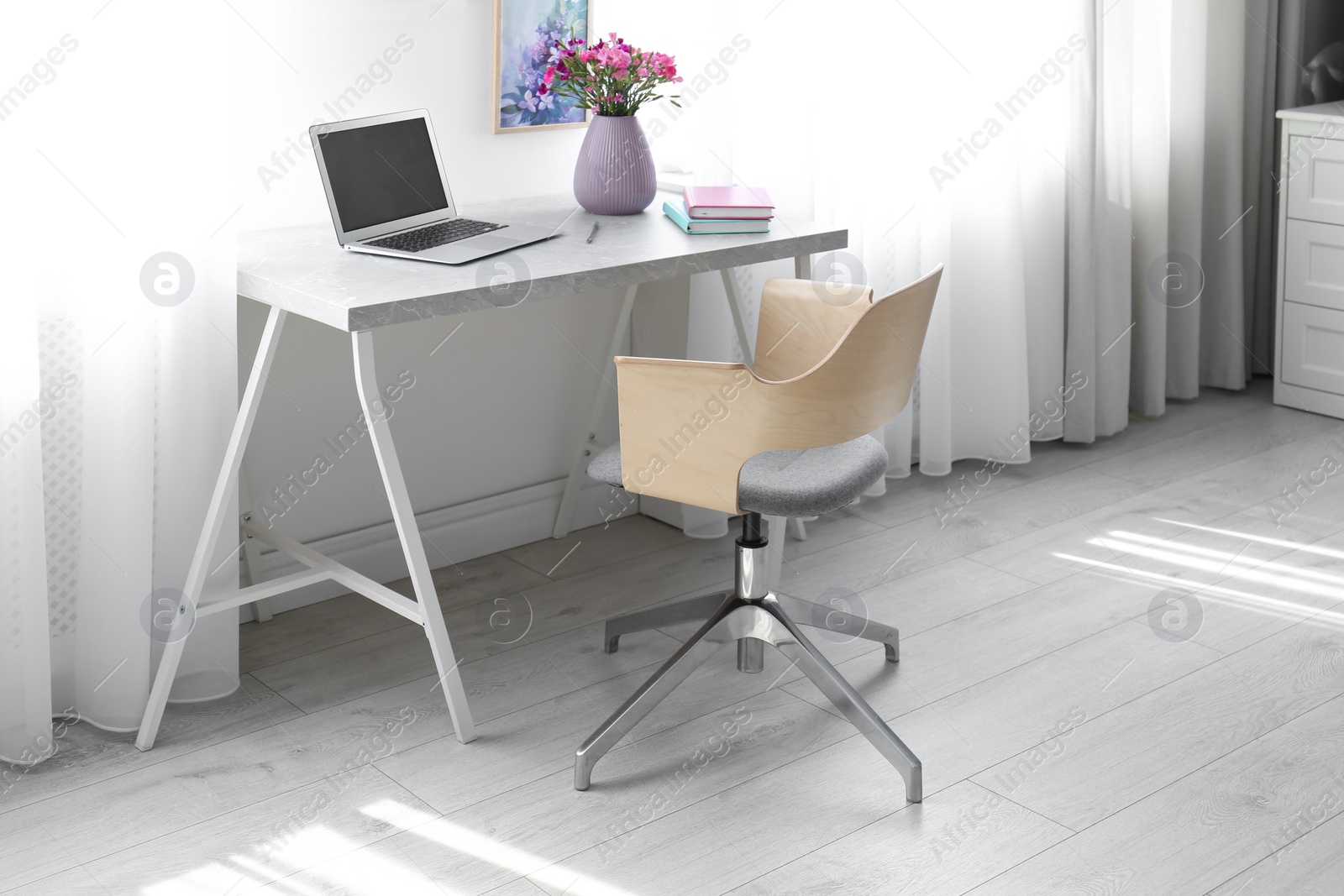 Photo of Comfortable workplace with office chair and modern table