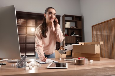 Photo of Seller talking on phone in office. Online store