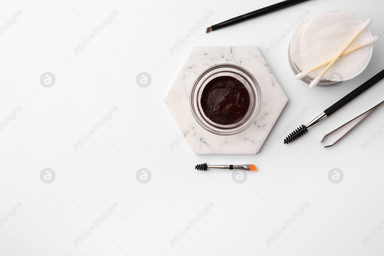 Photo of Flat lay composition with eyebrow henna and professional tools on white background, space for text