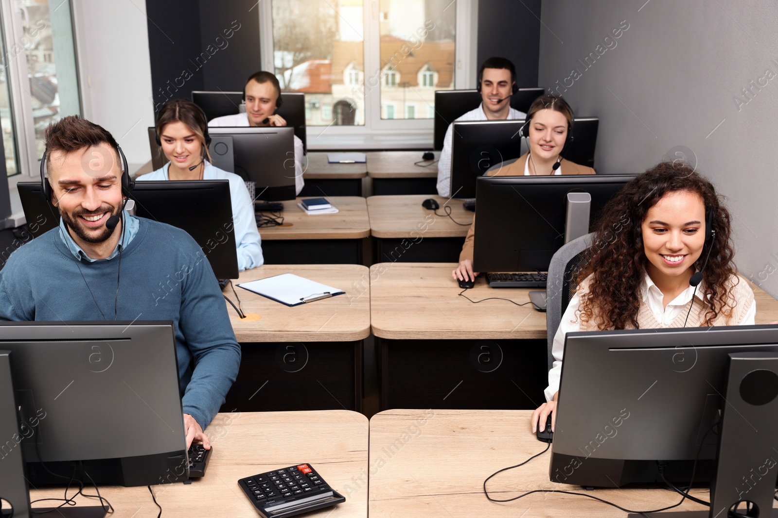 Photo of Call center operator working in modern office