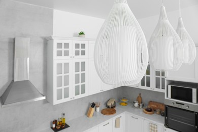 Stylish chandeliers in modern kitchen. Interior design
