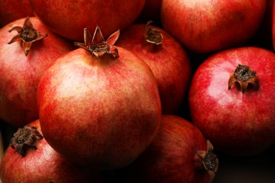 Many fresh ripe pomegranates as background, closeup