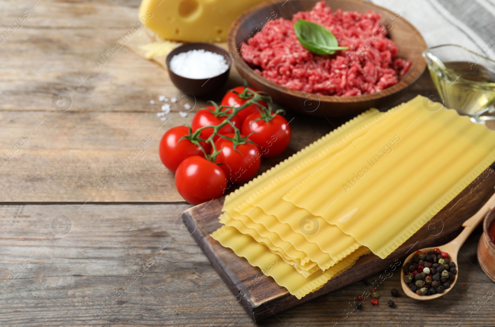 Photo of Fresh ingredients for lasagna on wooden table