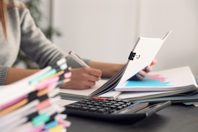 Office employee working with documents at table, closeup